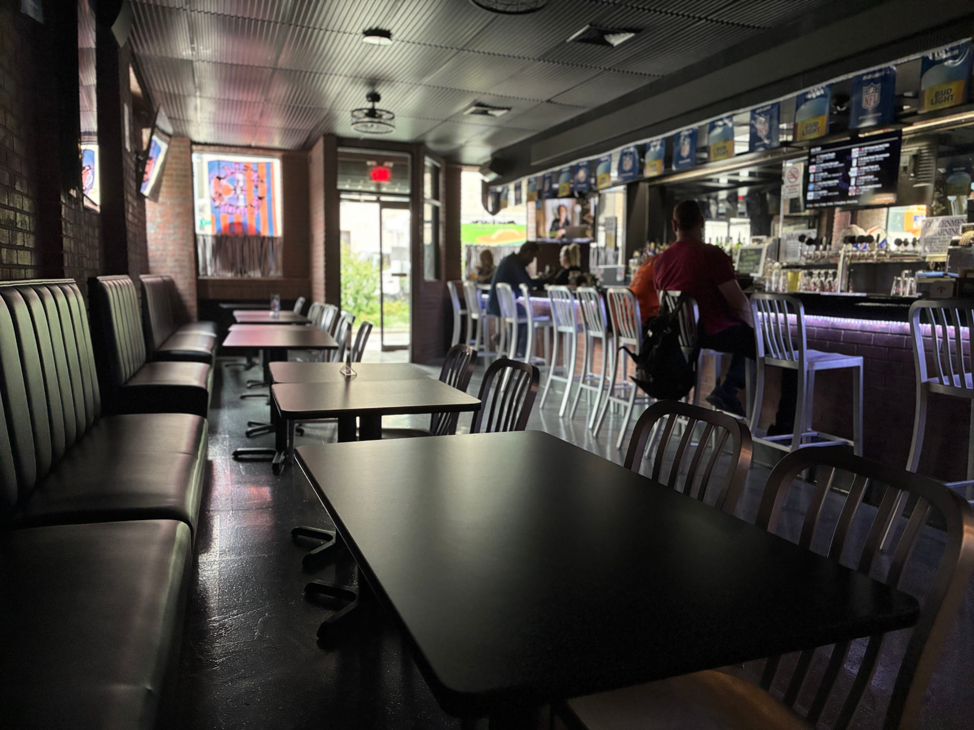 Tables, booths, and bar seating inside The Celly
