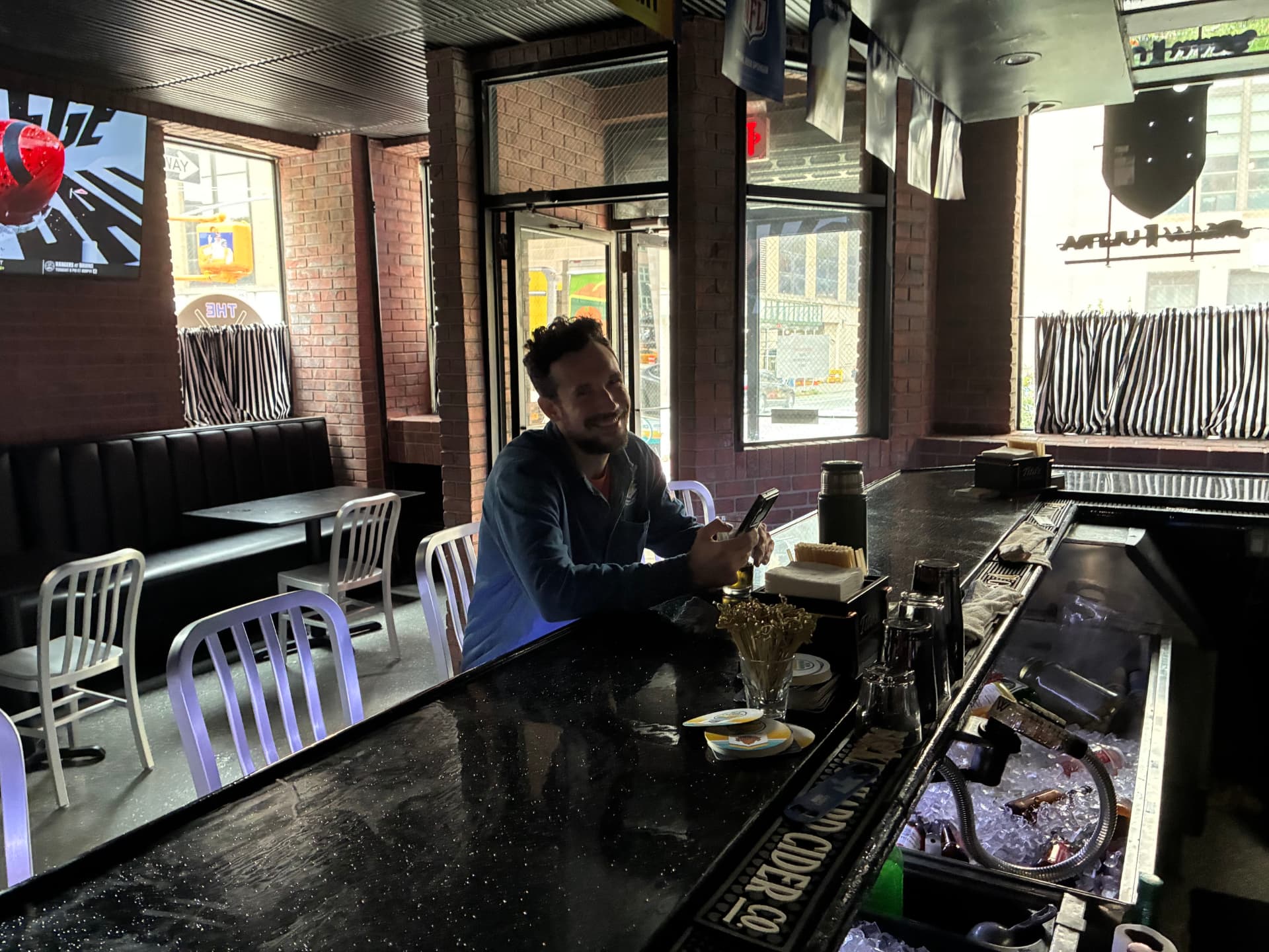 A regular posted up at the bar at The Celly