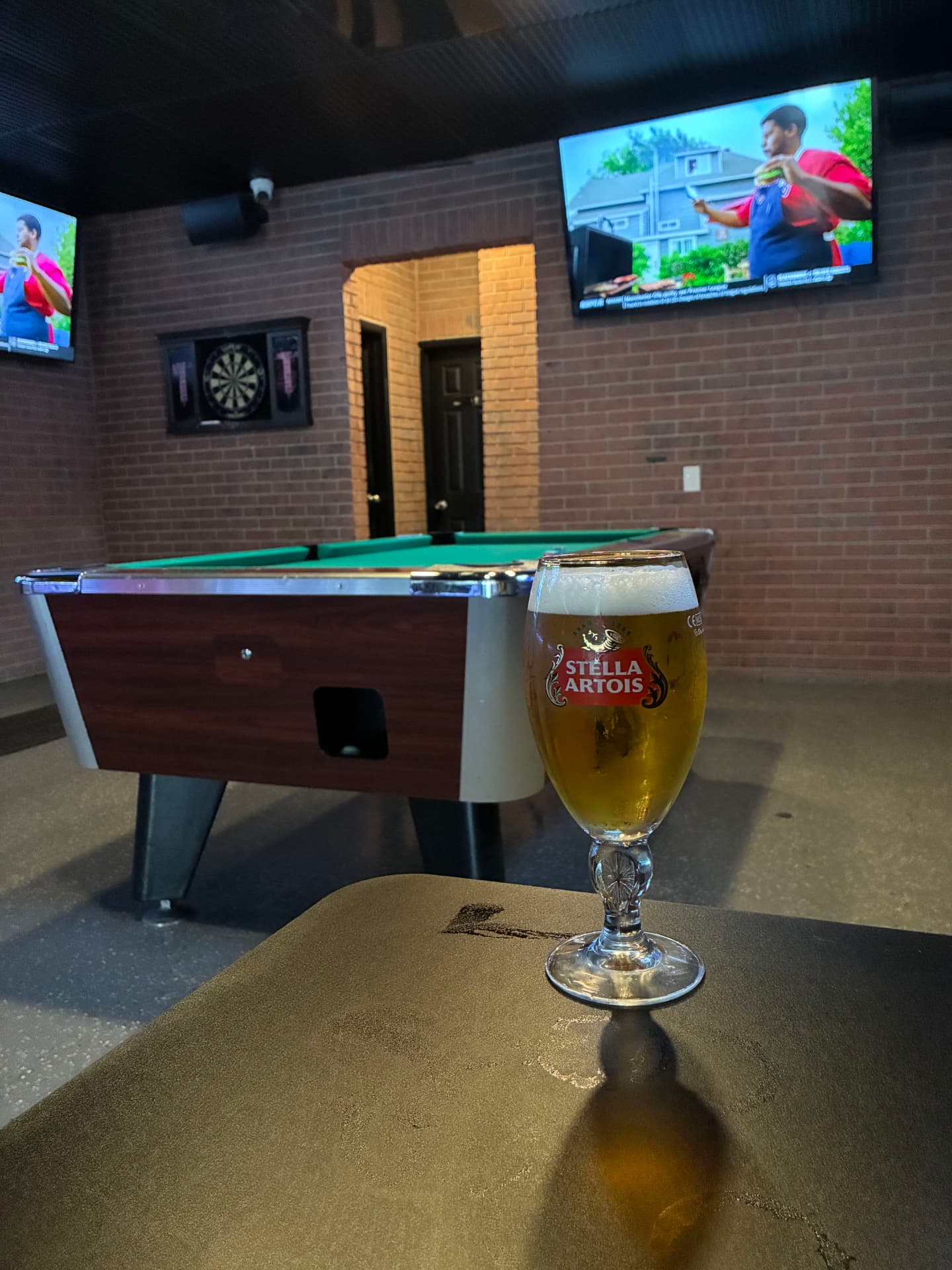A pint of Stella Artois by the pool table