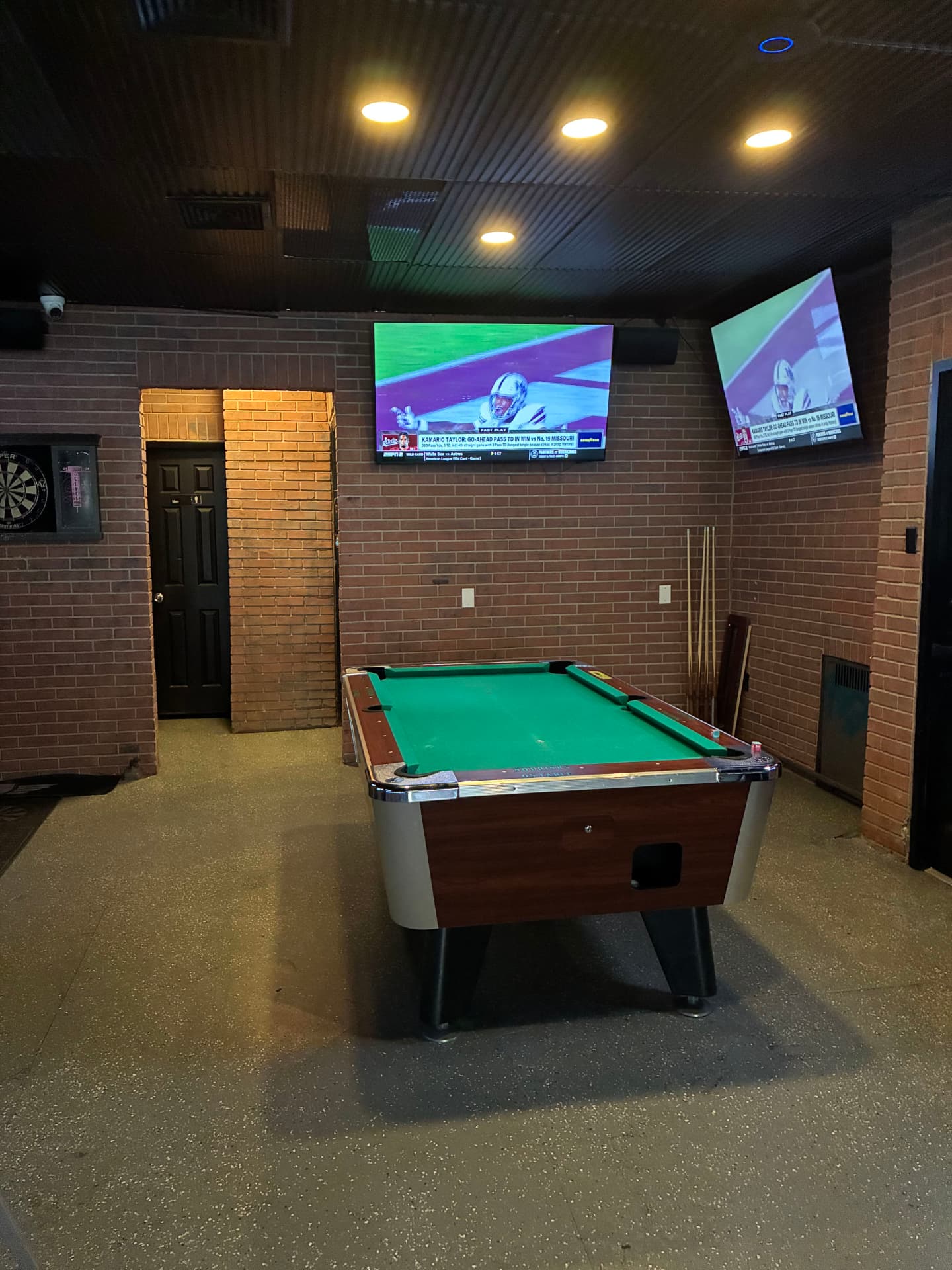 The pool table under the game-day TVs